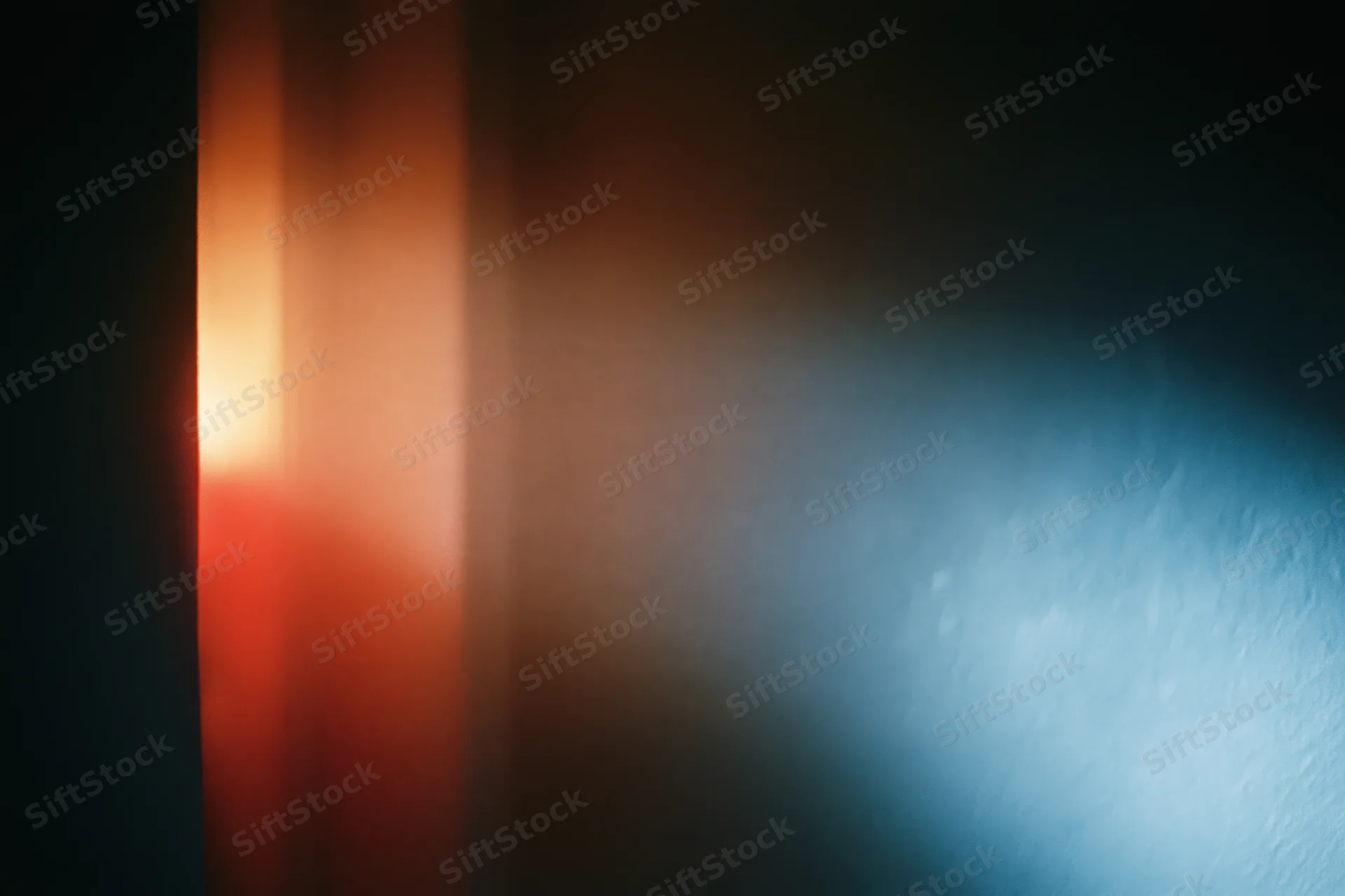 Warm and cool light sources meeting in a dark interior space