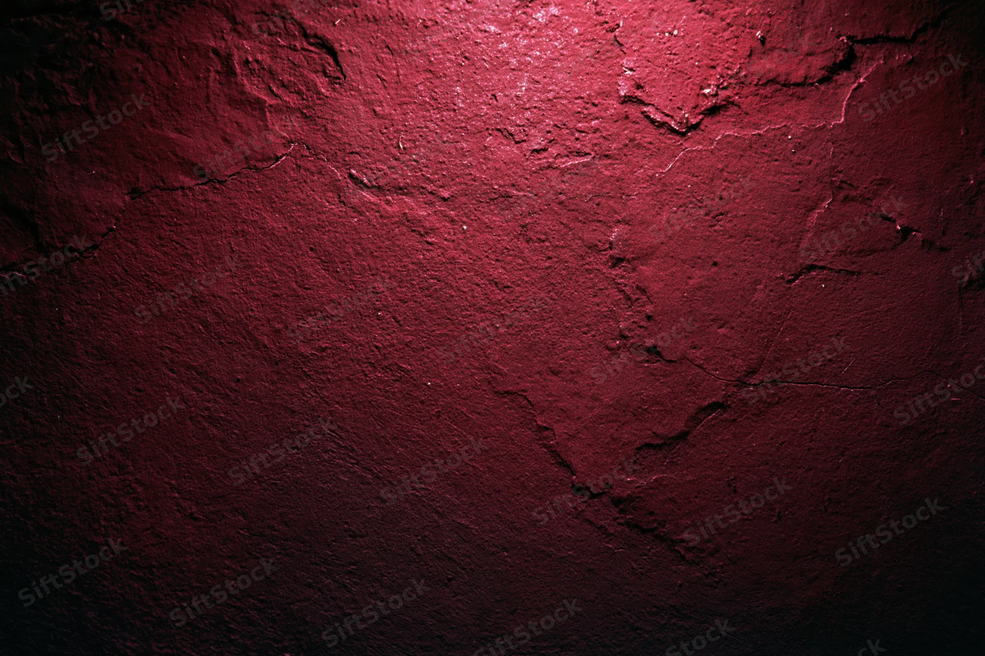 Weathered red concrete wall with cracked and peeling paint texture