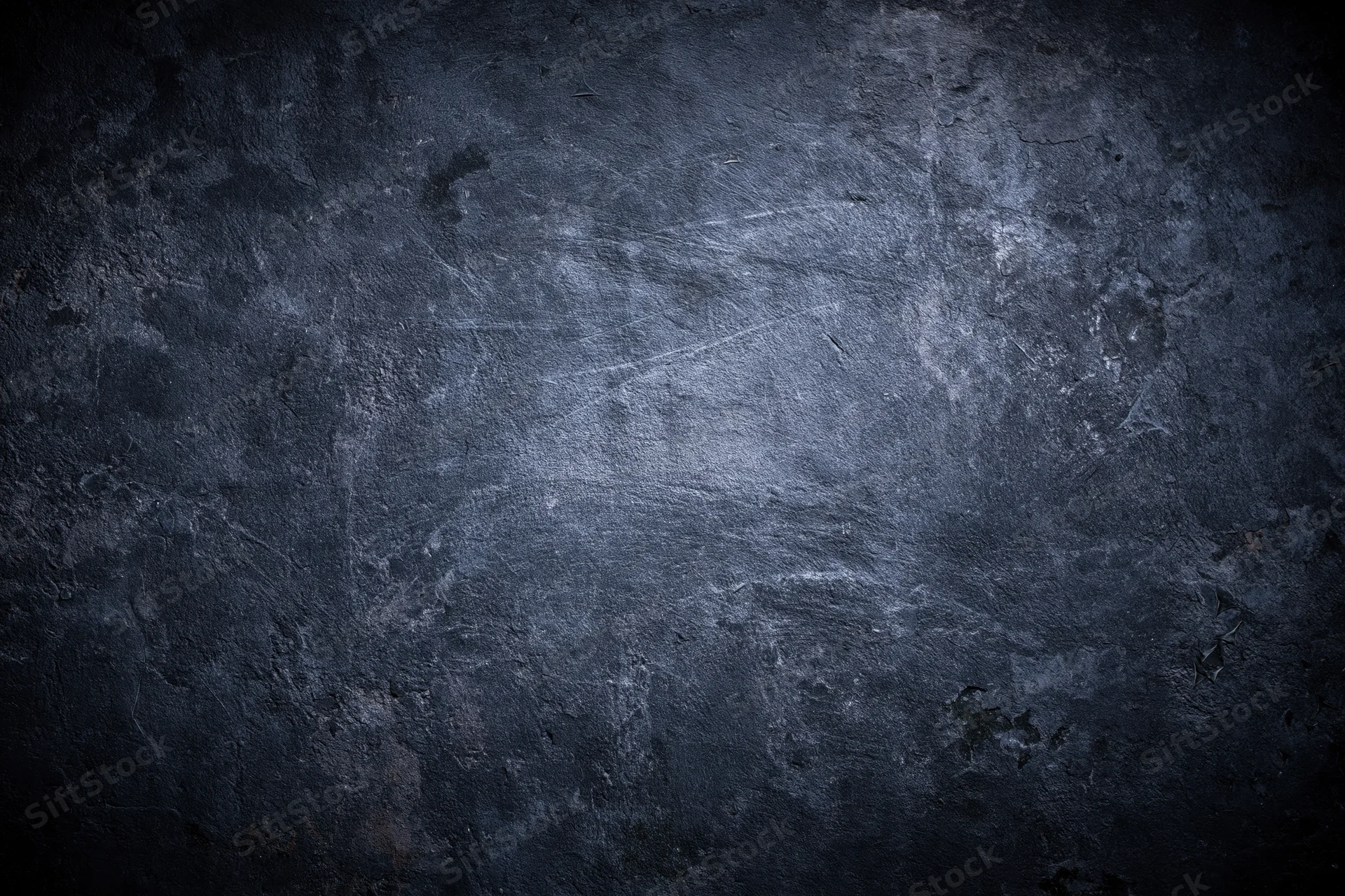 Weathered concrete wall surface with peeling paint and scratches