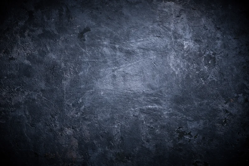Weathered concrete wall surface with peeling paint and scratches