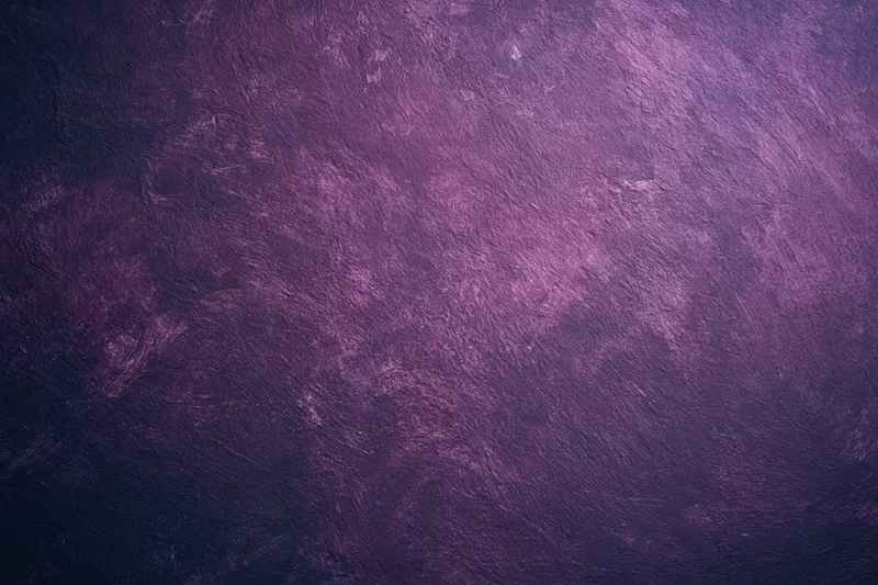 Weathered purple plaster wall surface filling the frame