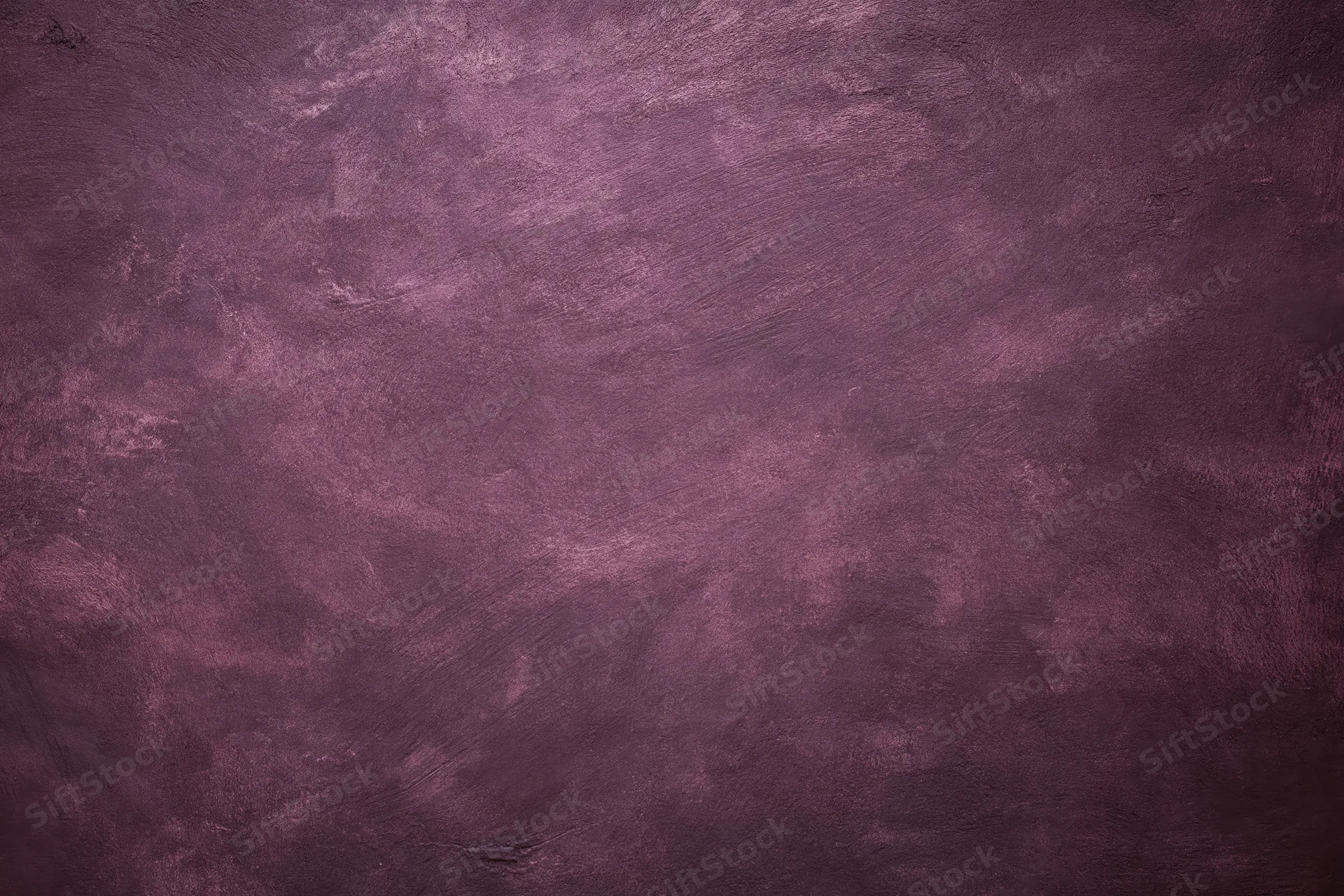 Weathered plaster wall surface filling the frame with textured purple and gray tones