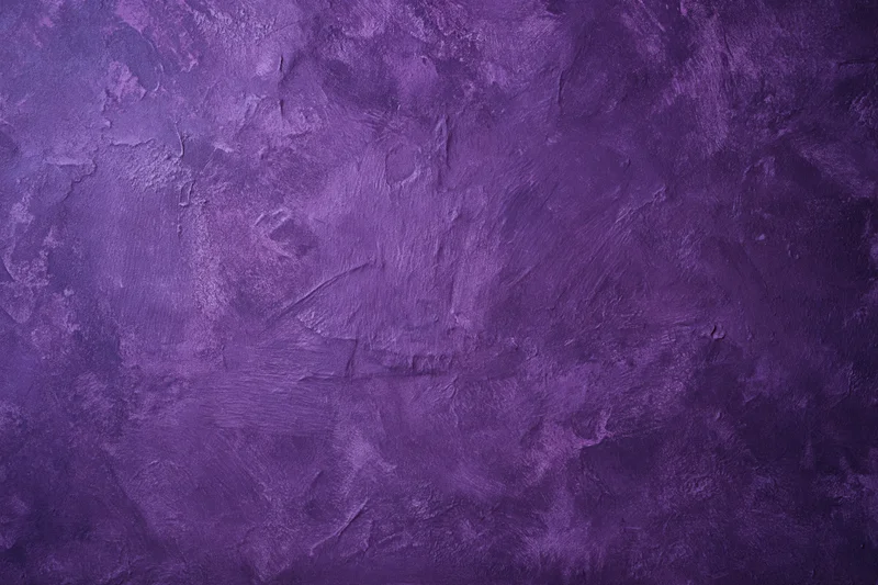 Weathered purple plaster wall surface filling the frame