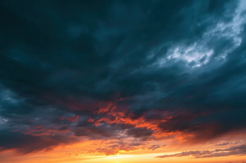 Dramatic sky at sunset with layered clouds and vibrant orange and blue hues