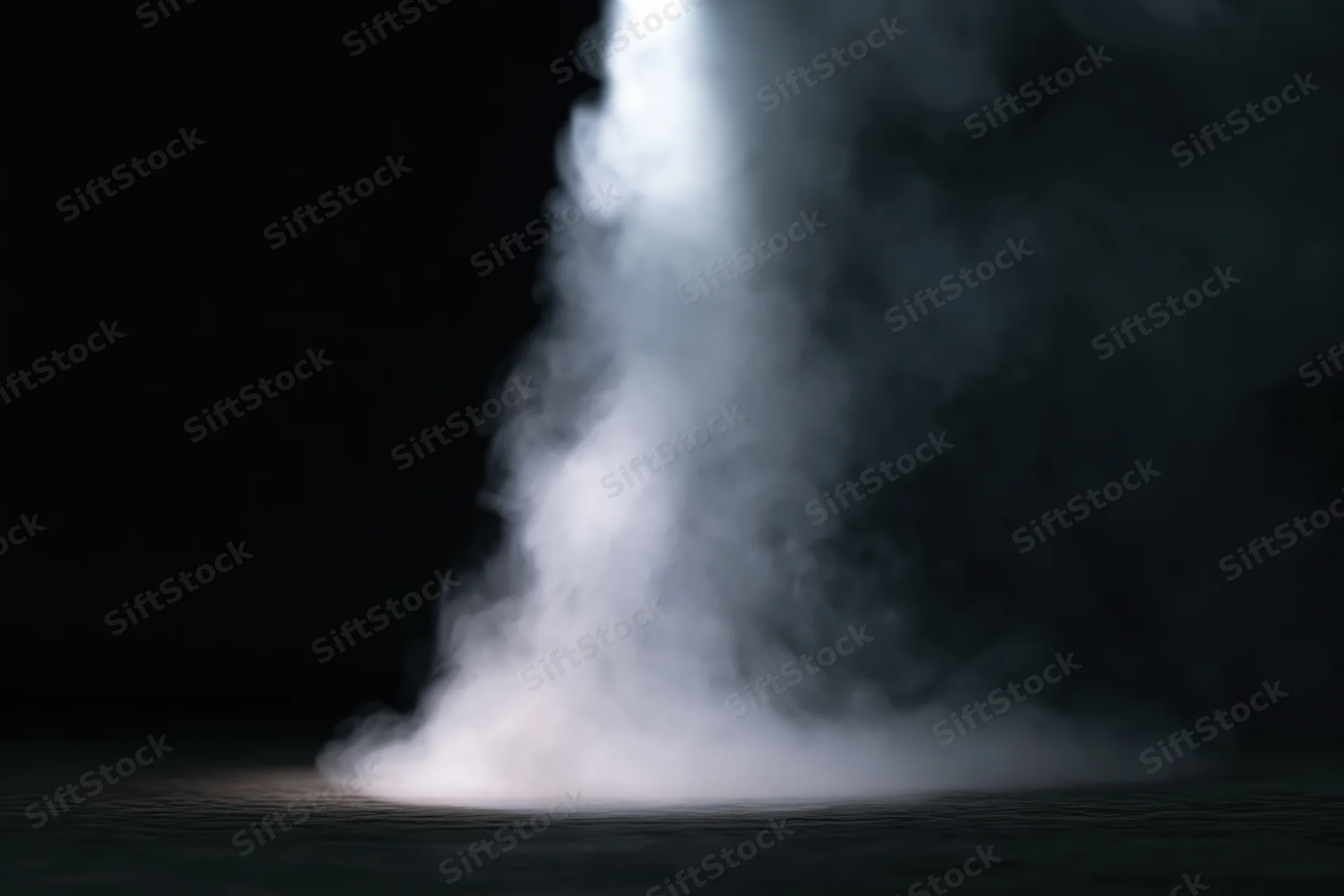 White smoke rising from a dark surface in a studio setting