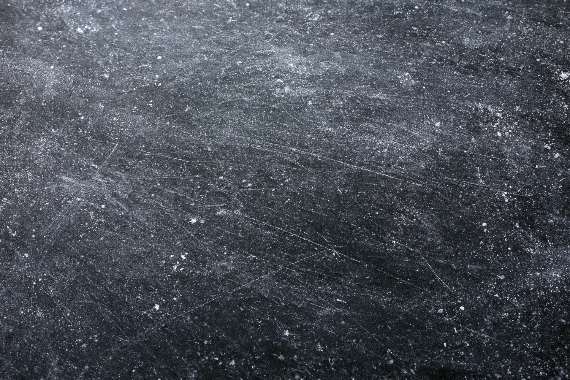 Worn black chalkboard surface covered in chalk dust and fine scratches
