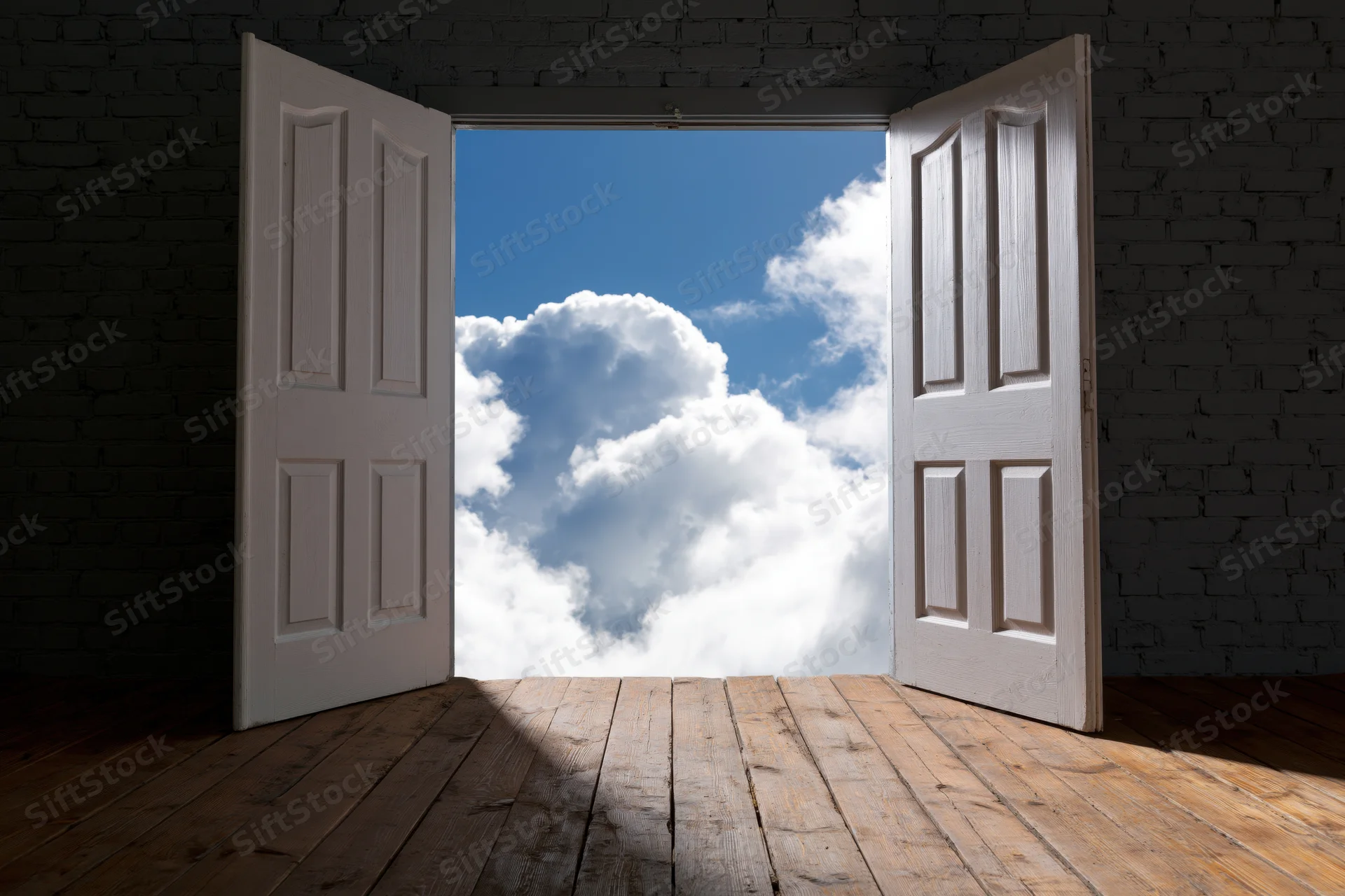 White double doors open wide to a bright blue sky with fluffy clouds, revealing a view from a dark brick room with wooden floor