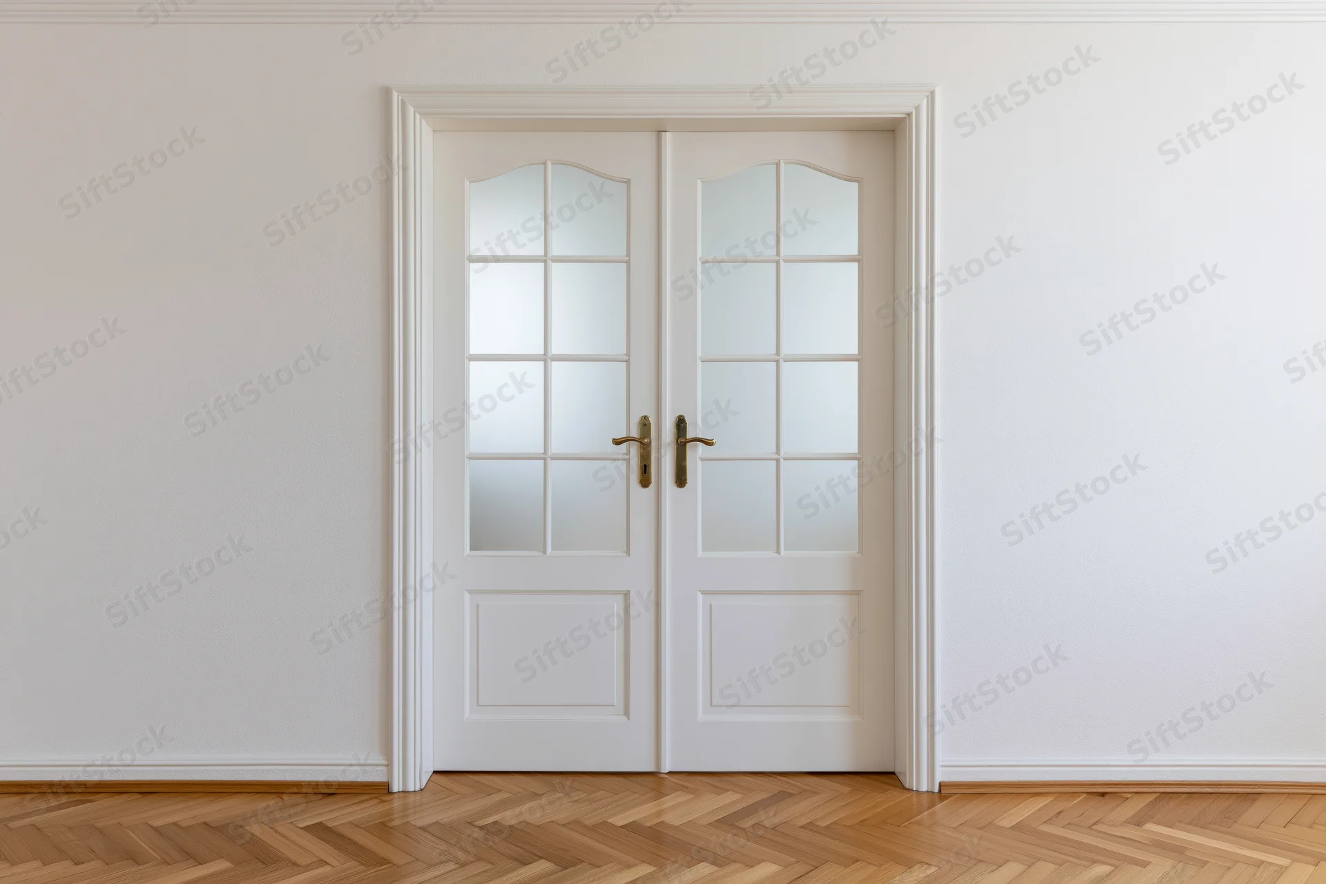 White double doors with arched frosted glass panels in a minimalist interior with parquet flooring