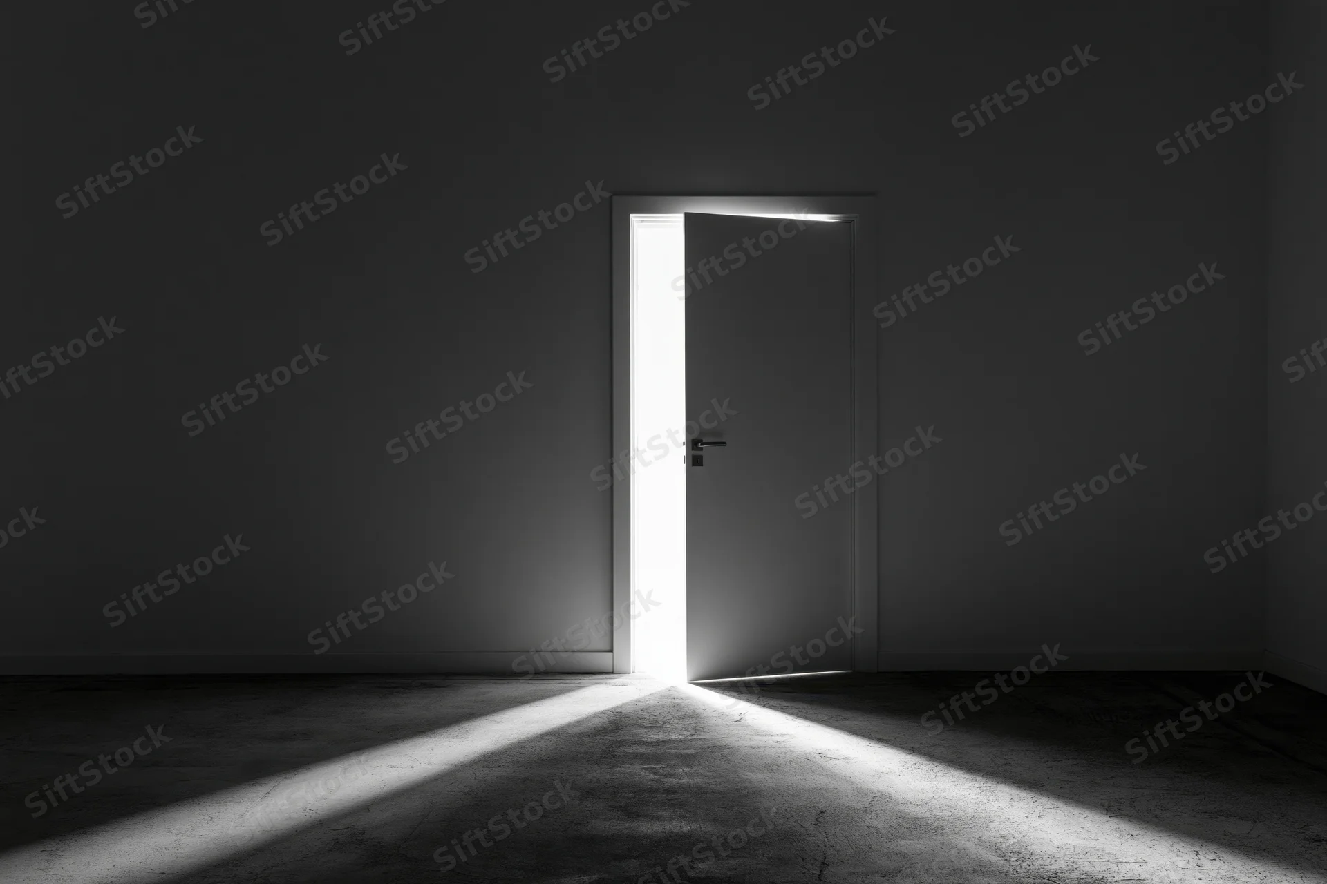 Slightly ajar door in dark empty room letting in bright light beam
