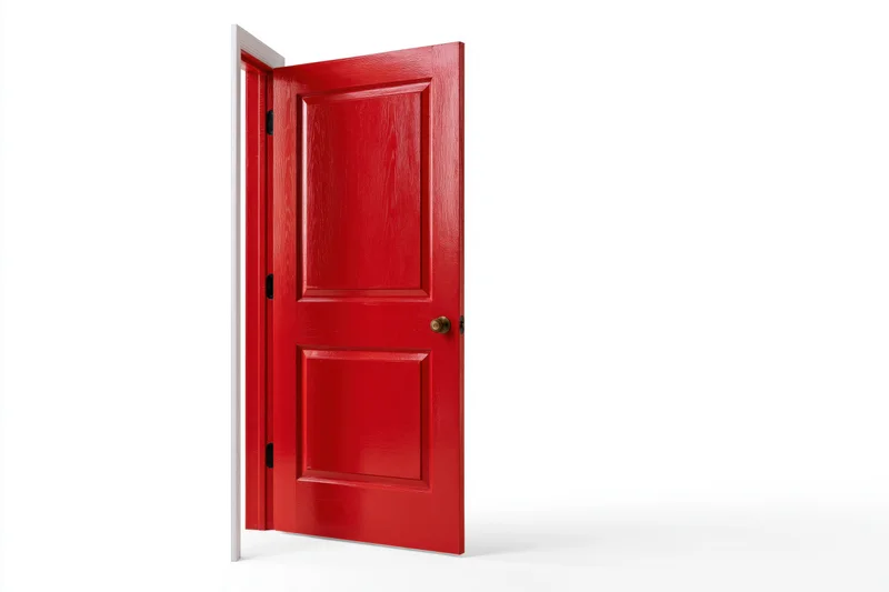 Red painted wooden interior door half-open against white background