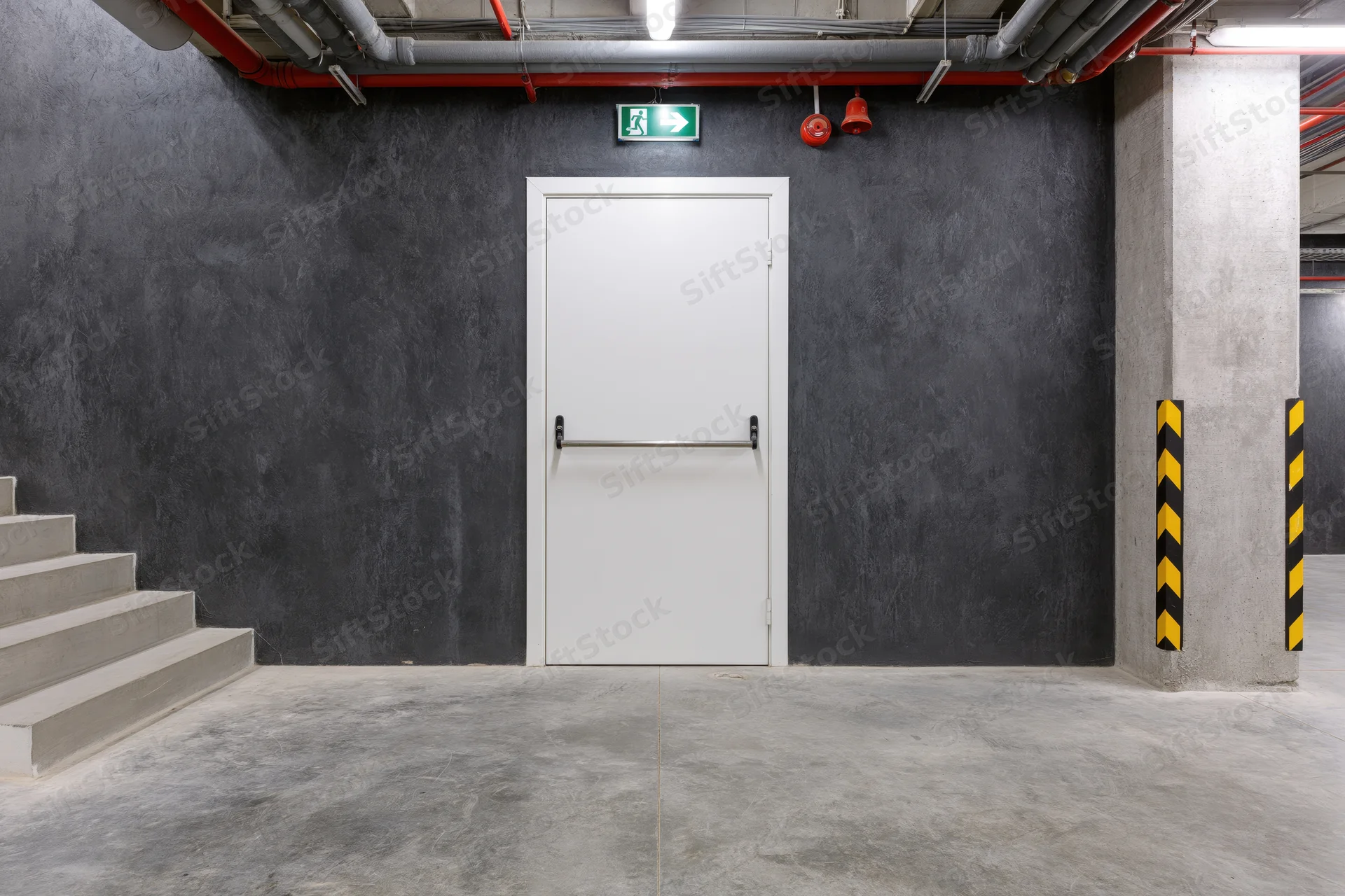 White fire exit door with push bar in a commercial building interior