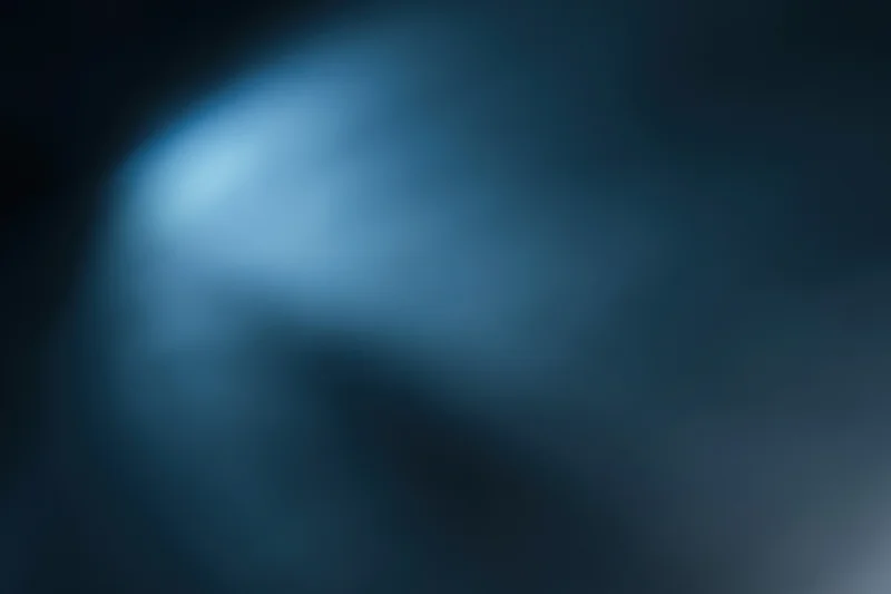 Abstract defocused blue gradient background with soft light and dark tones