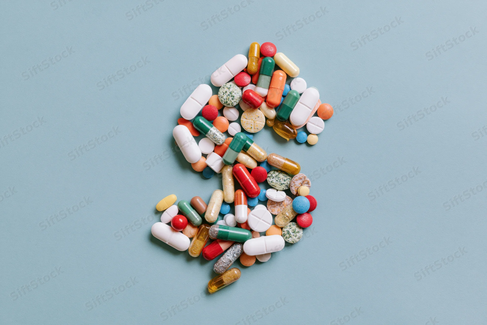 Assorted colorful pills capsules and tablets arranged in the shape
