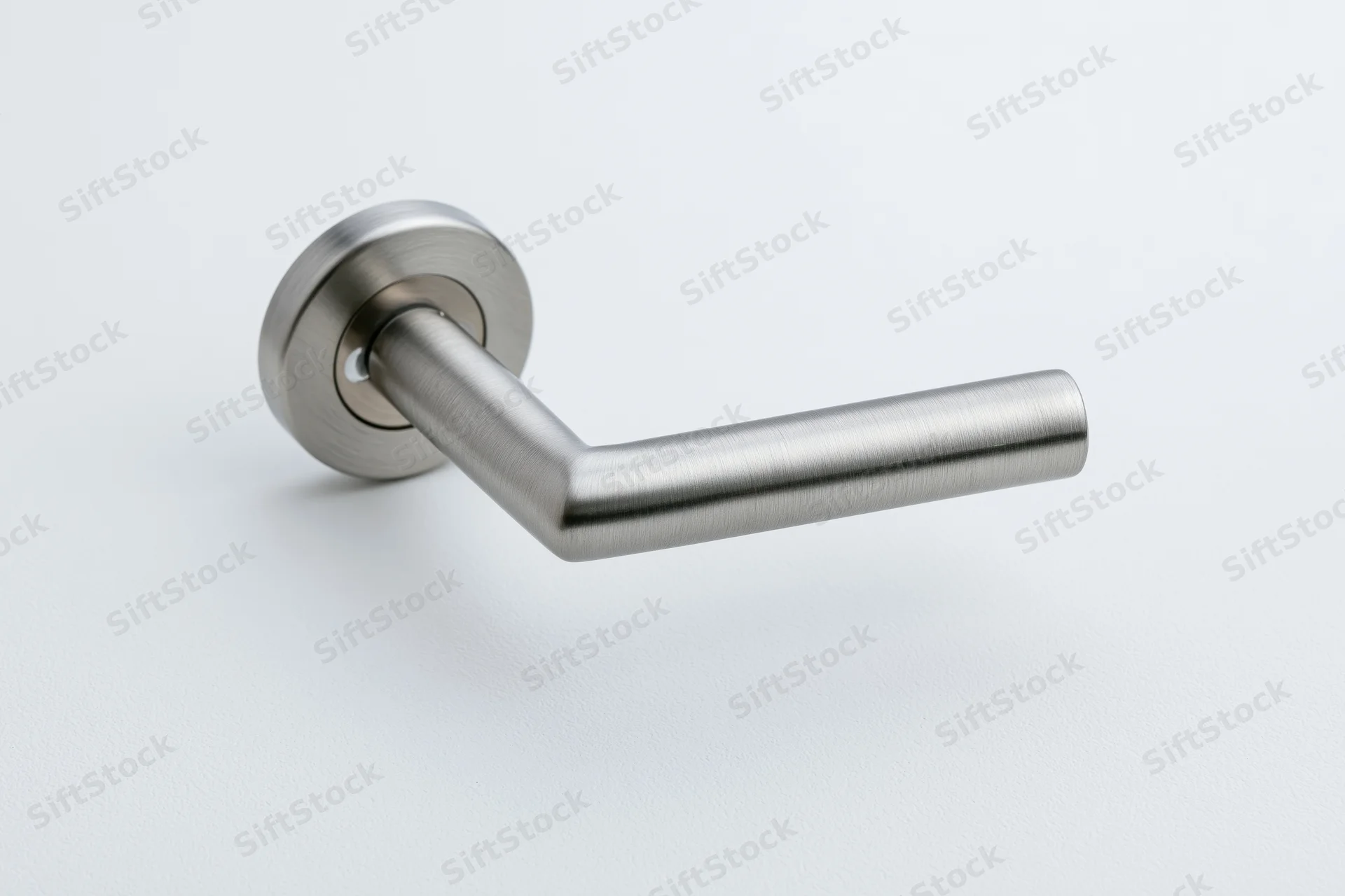 Brushed stainless steel door lever handle with round keyhole on white background