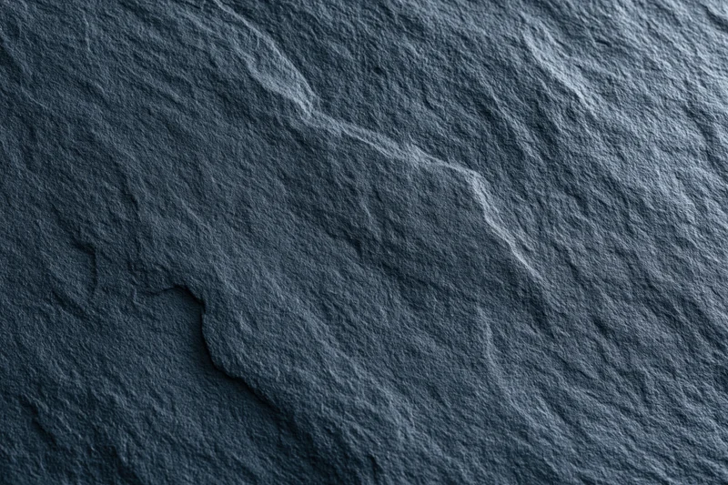 Close-up of dark slate stone surface with natural texture and grain
