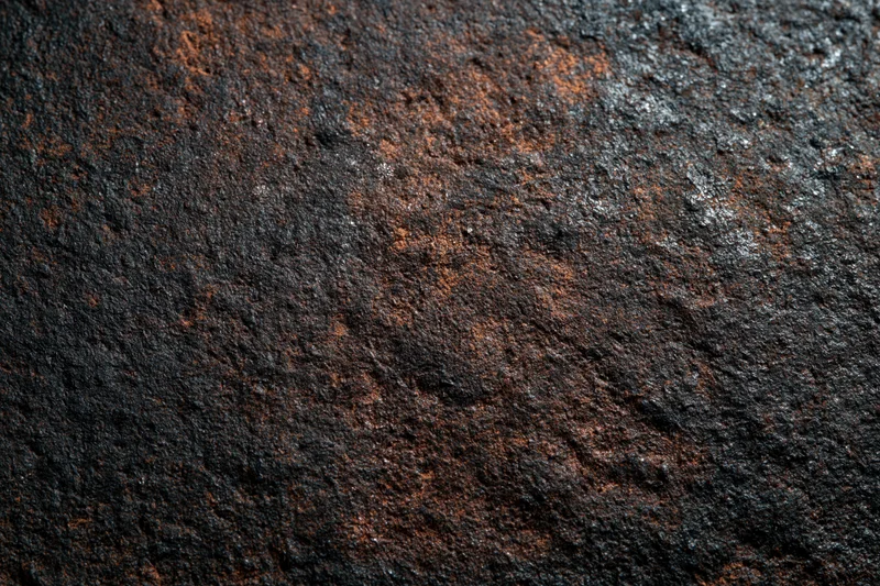 Close-up of a heavily oxidized metal surface with rust and corrosion patterns