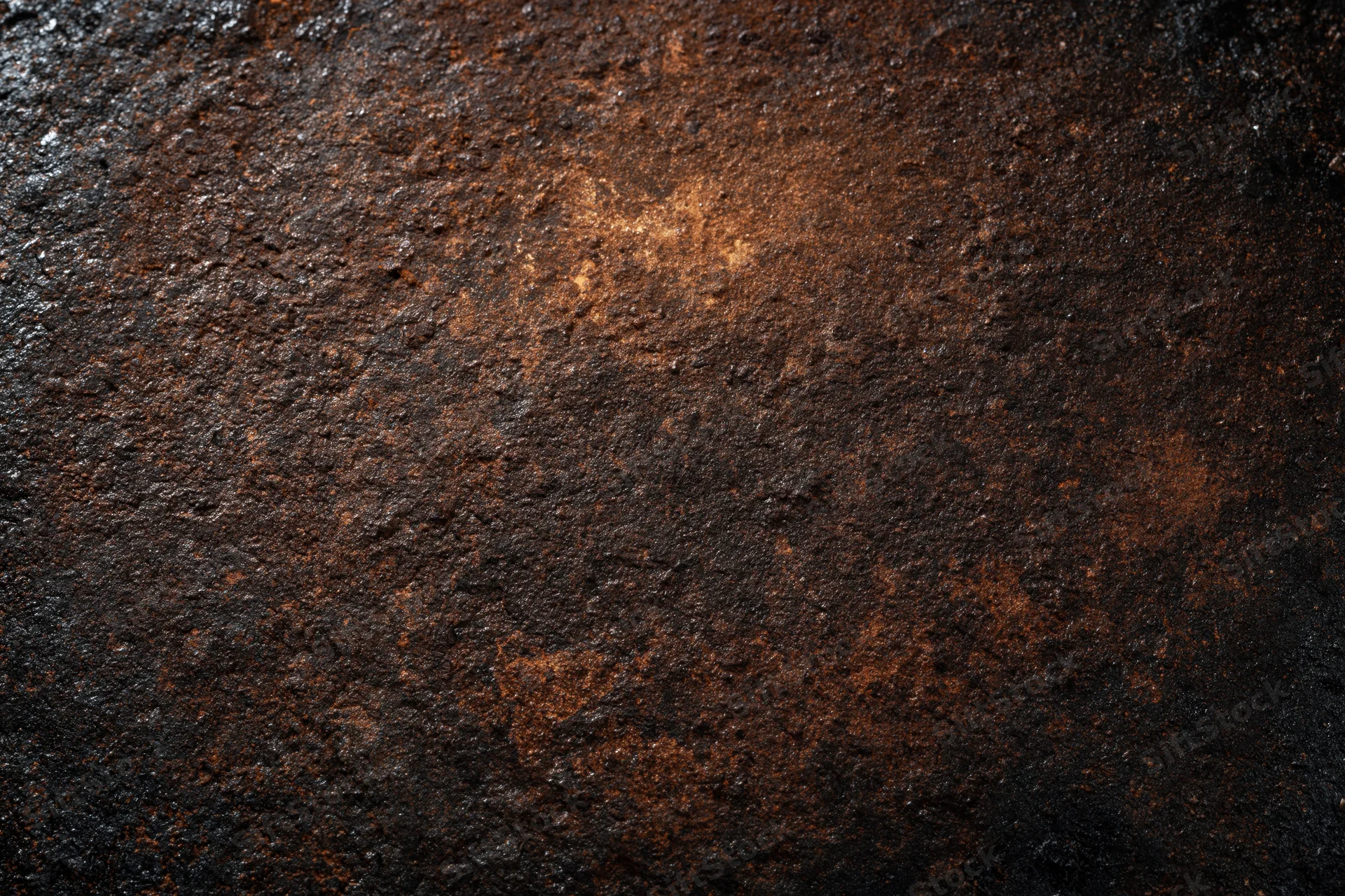 Close-up of a heavily oxidized metal surface with rough texture and dark brown rust patterns
