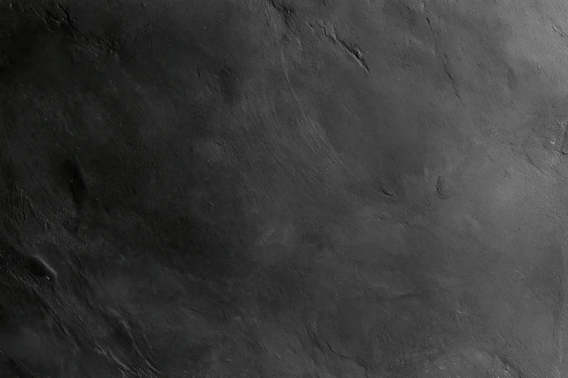 Close-up of rough concrete wall surface with cracks and texture