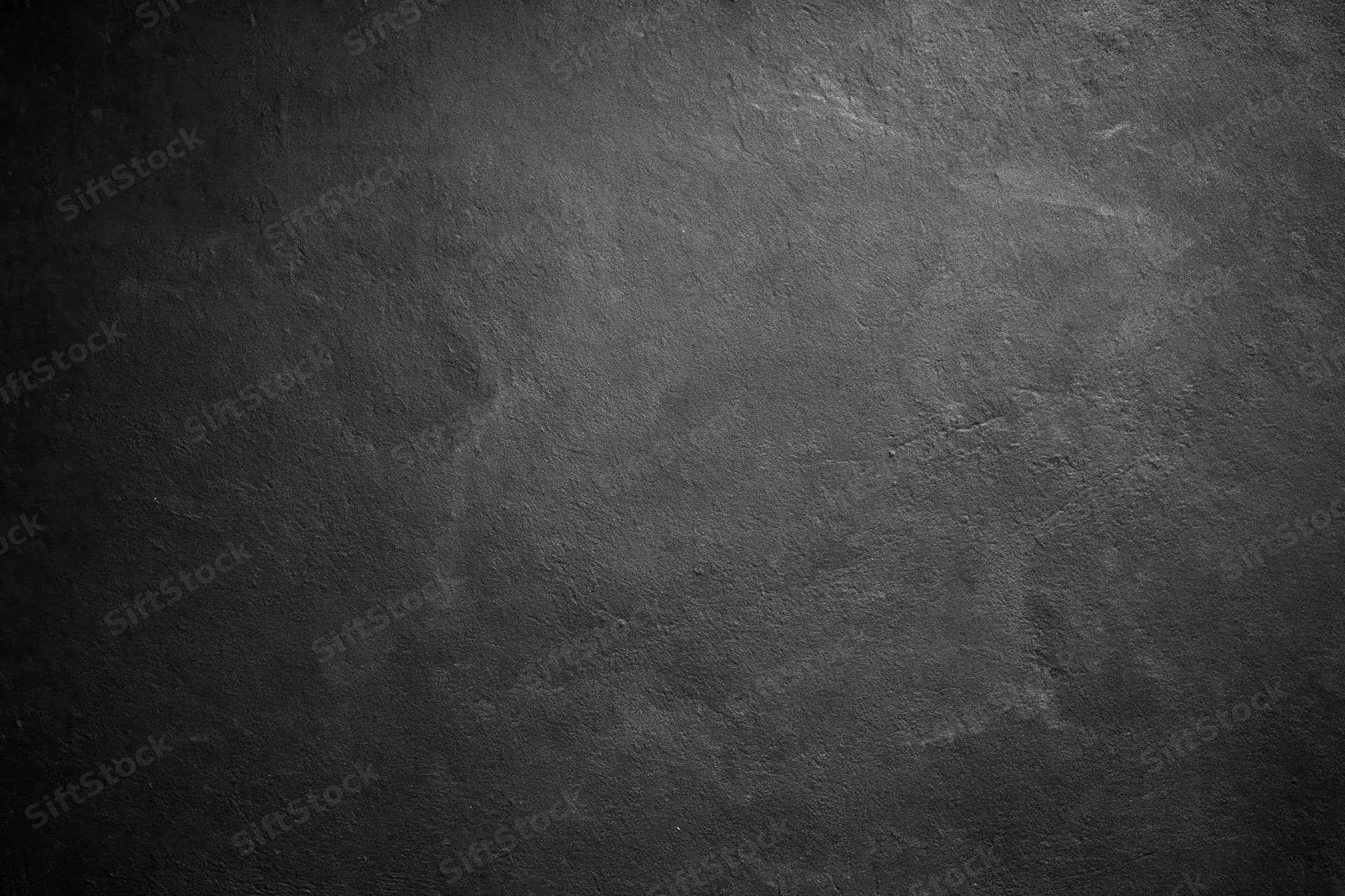 Close-up of rough concrete wall surface with textured gray finish