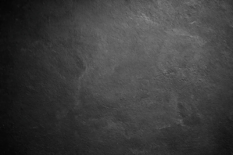 Close-up of rough concrete wall surface with textured gray finish