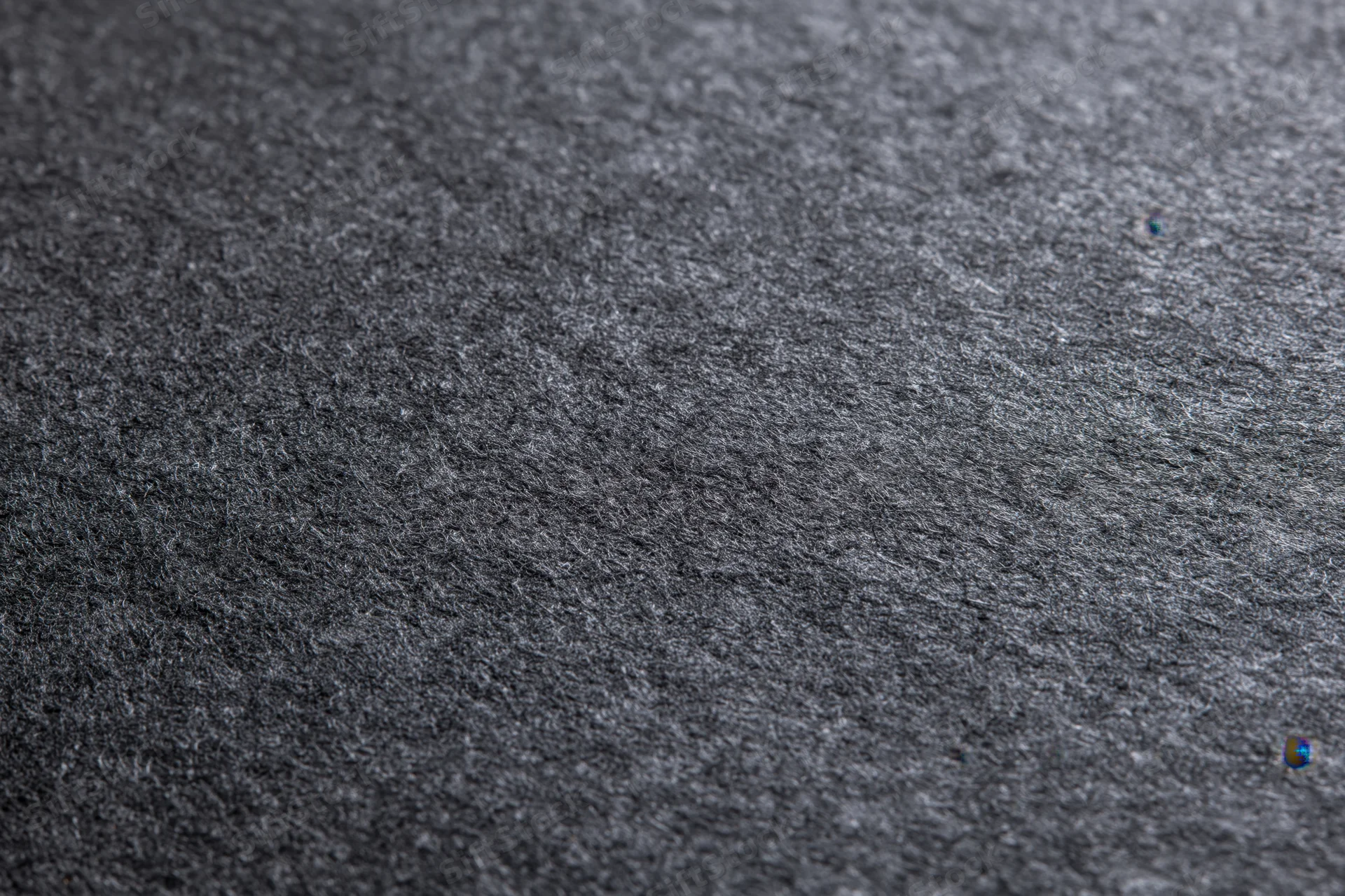 Close-up of dark charcoal grey textured paper surface