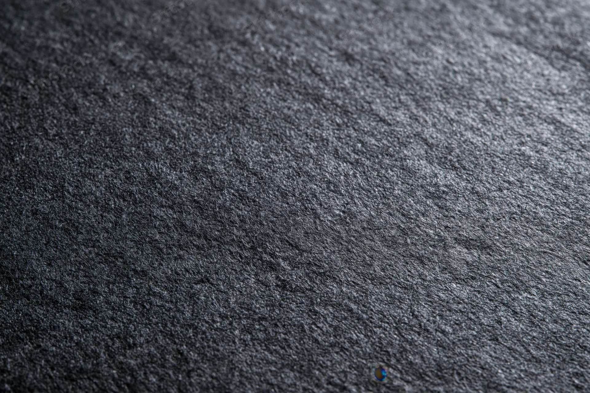 Close-up of dark charcoal grey textured paper surface in flat lay arrangement