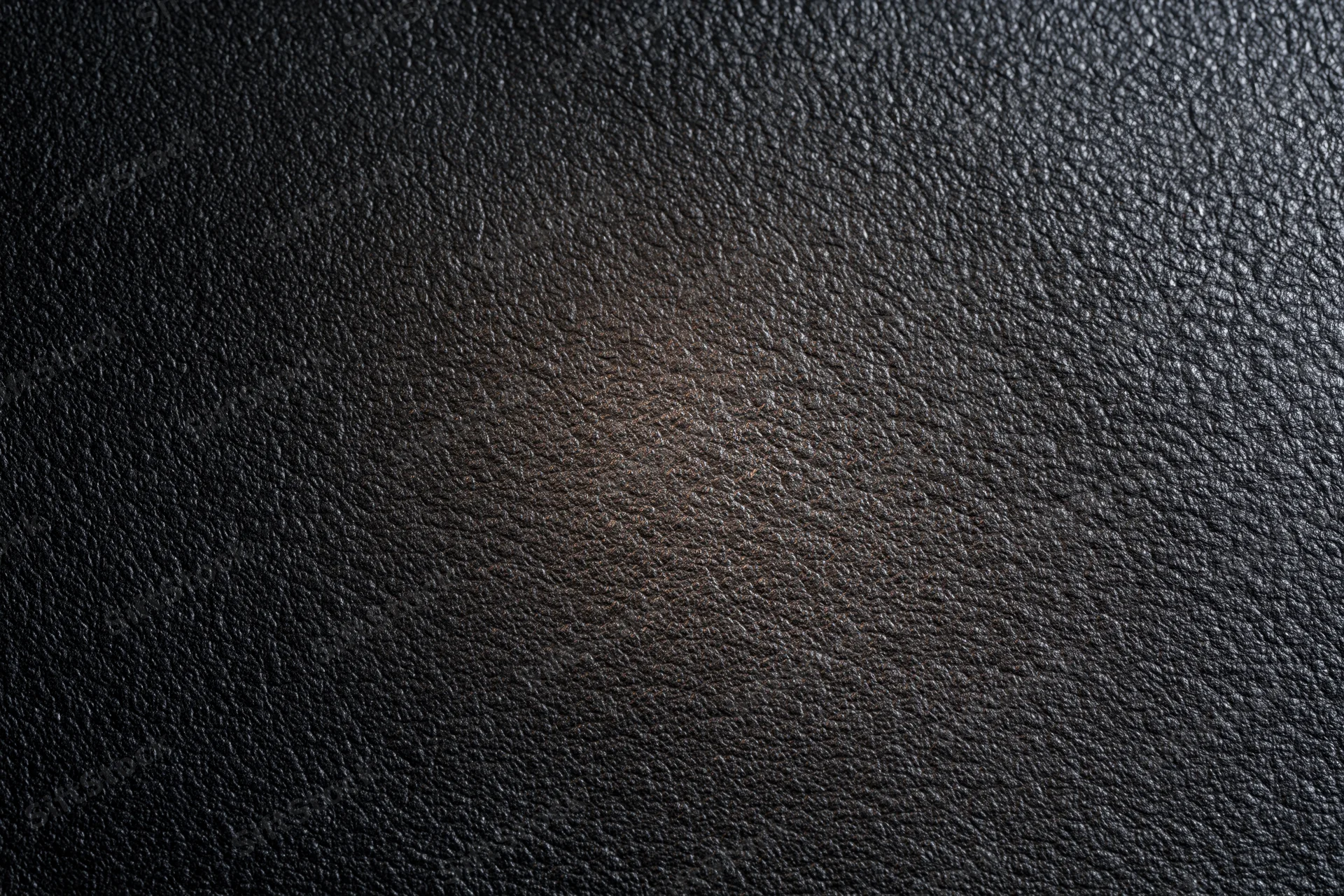 Close-up of dark charcoal leather surface with visible grain texture