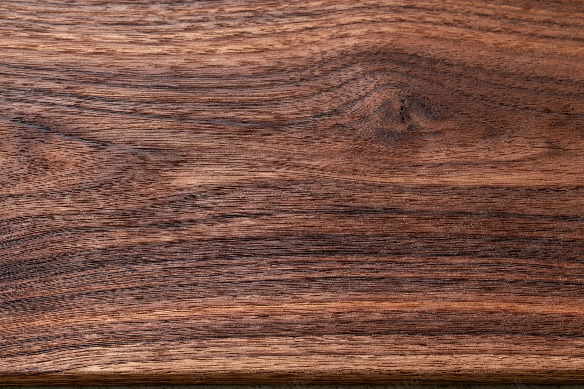 Close-up of dark walnut wood grain surface filling the frame