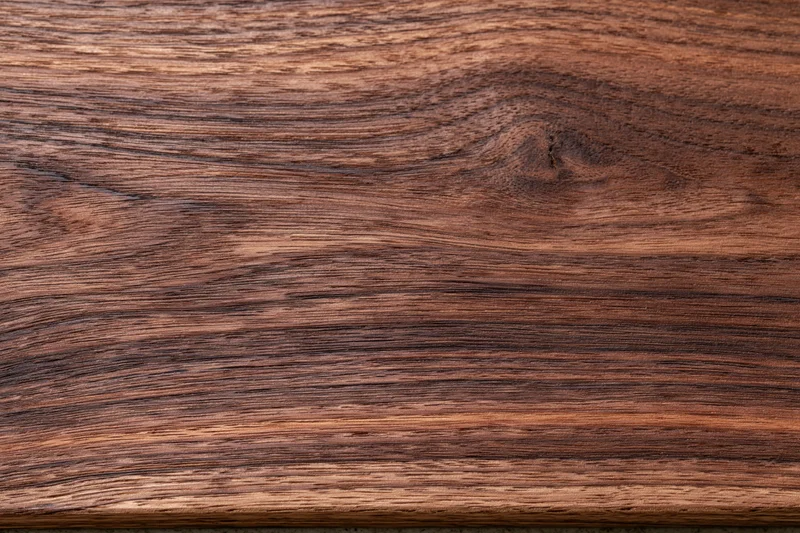 Close-up of dark walnut wood grain surface filling the frame