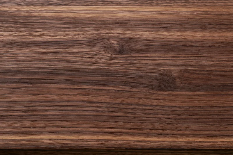Close-up of dark walnut wood grain surface filling the frame