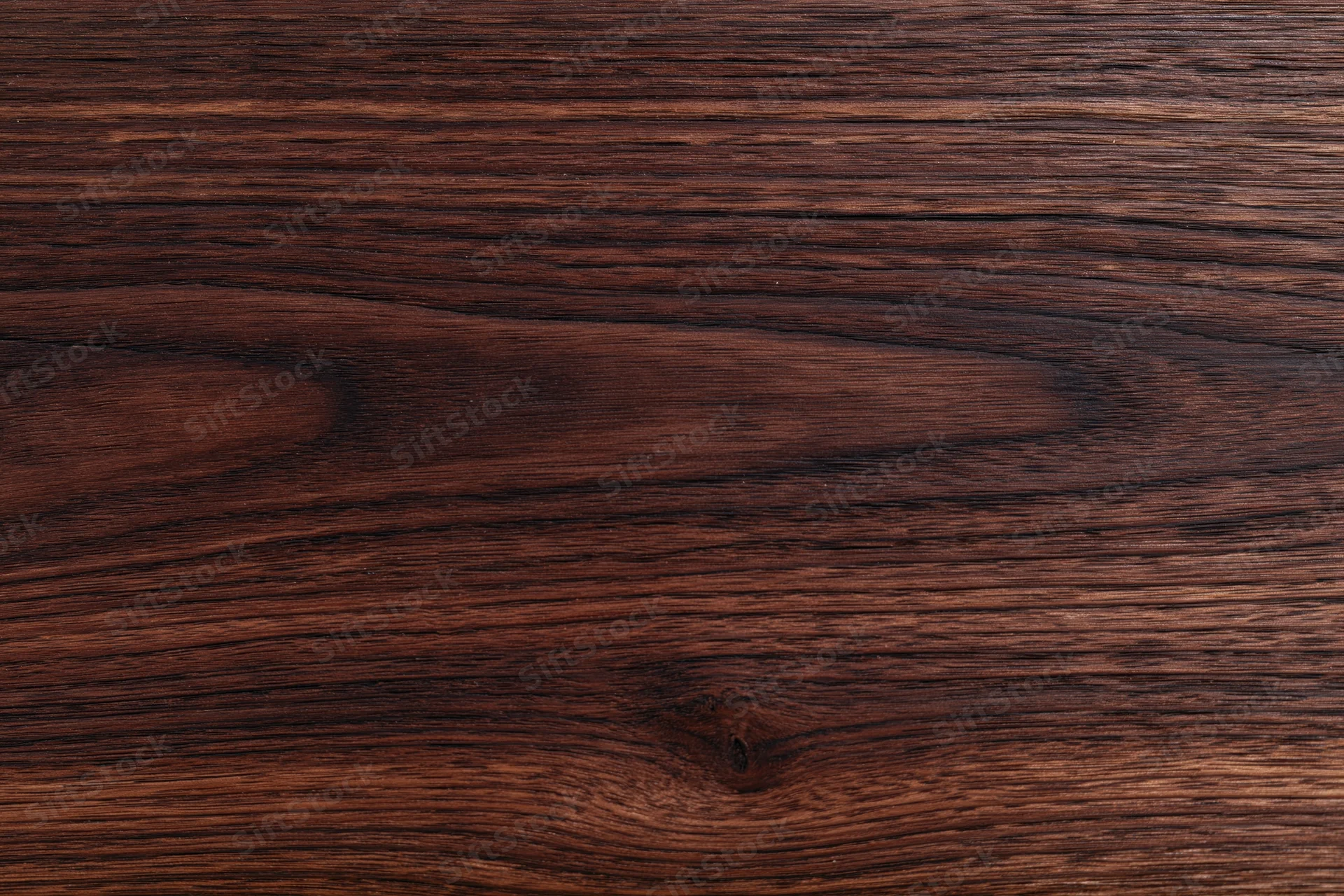 Close-up of dark walnut wood grain surface filling the frame