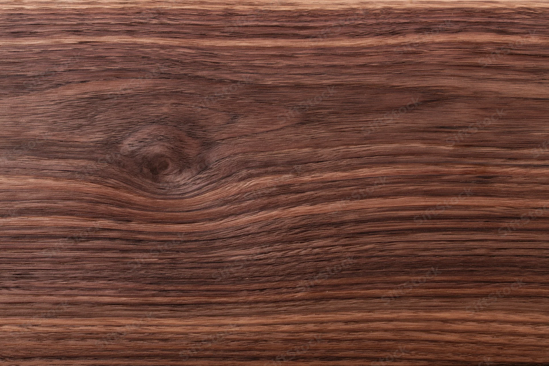 Close-up of dark walnut wood grain surface filling the frame
