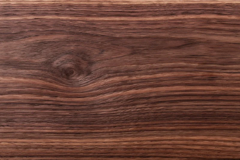 Close-up of dark walnut wood grain surface filling the frame