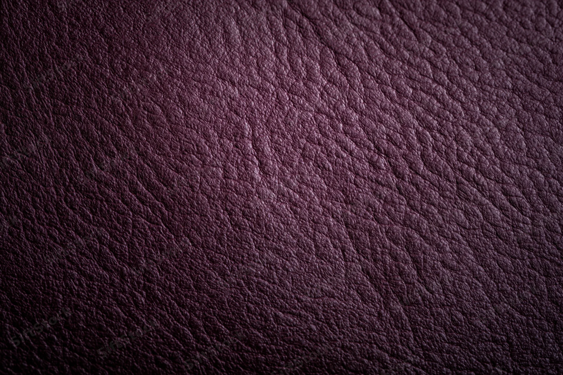Close-up of deep purple leather surface showing natural grain and texture