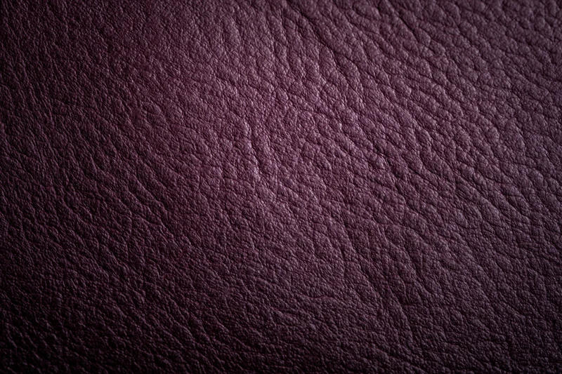 Close-up of deep purple leather surface showing natural grain and texture