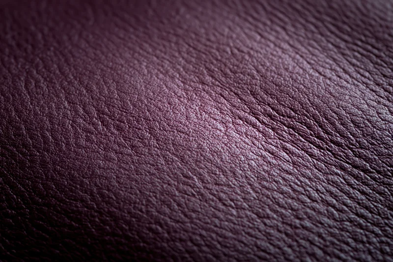Close-up of deep purple leather surface showing natural grain and texture