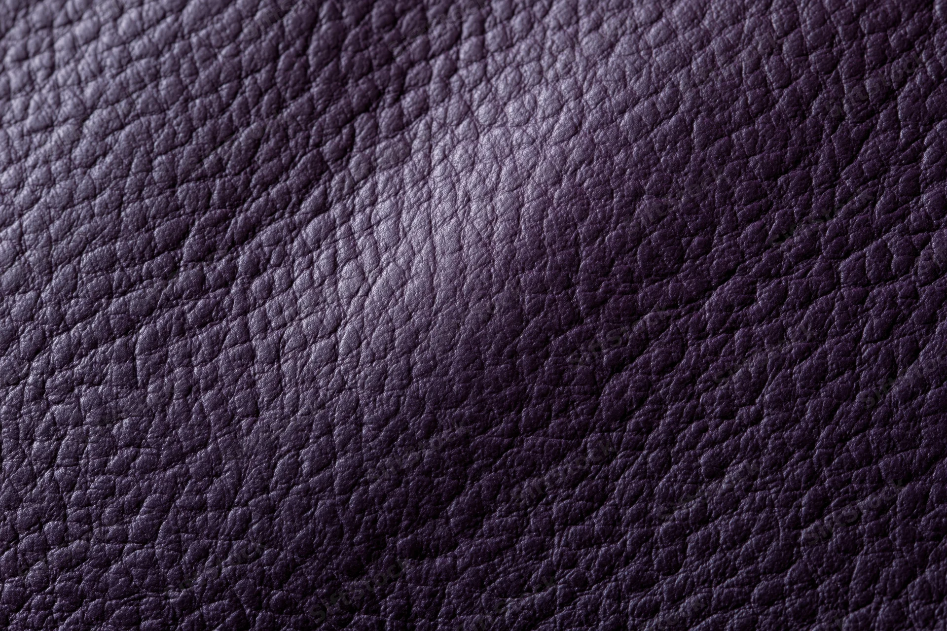 Close-up of deep purple leather surface showing detailed grain texture