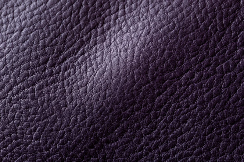 Close-up of deep purple leather surface showing detailed grain texture