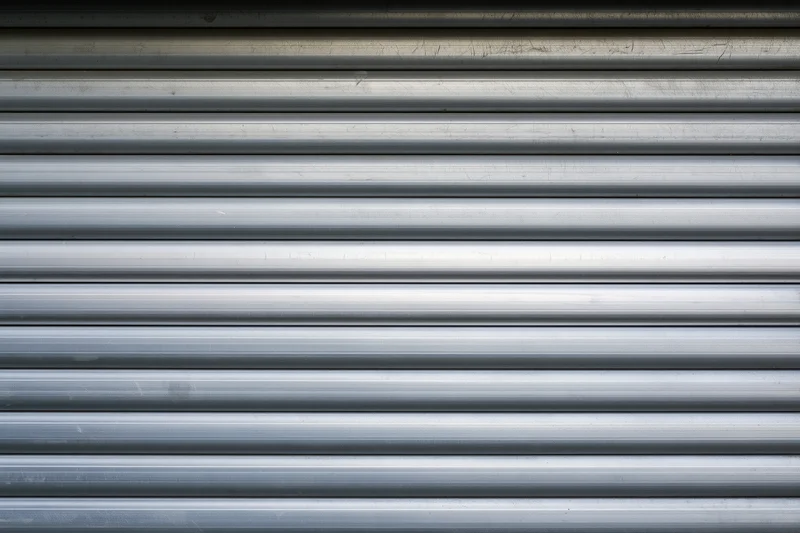 Close-up of a corrugated metal roller shutter door on a commercial building exterior