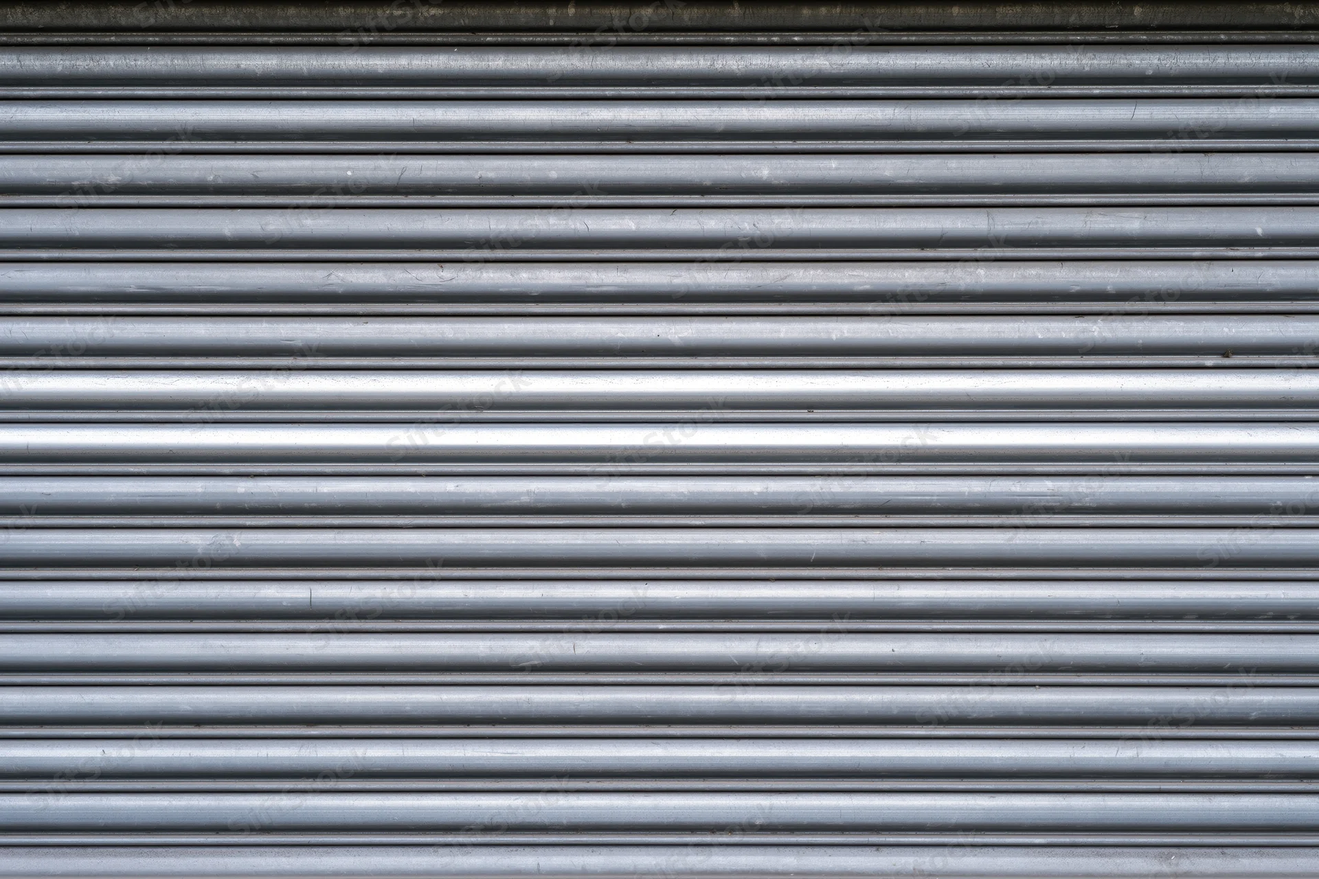 Close-up of a corrugated metal roller shutter door on a building exterior