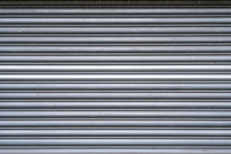 Close-up of a corrugated metal roller shutter door on a building exterior