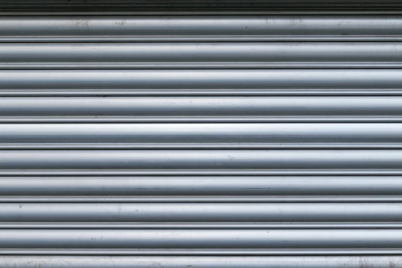 Close-up of a corrugated metal roller shutter door on a building exterior