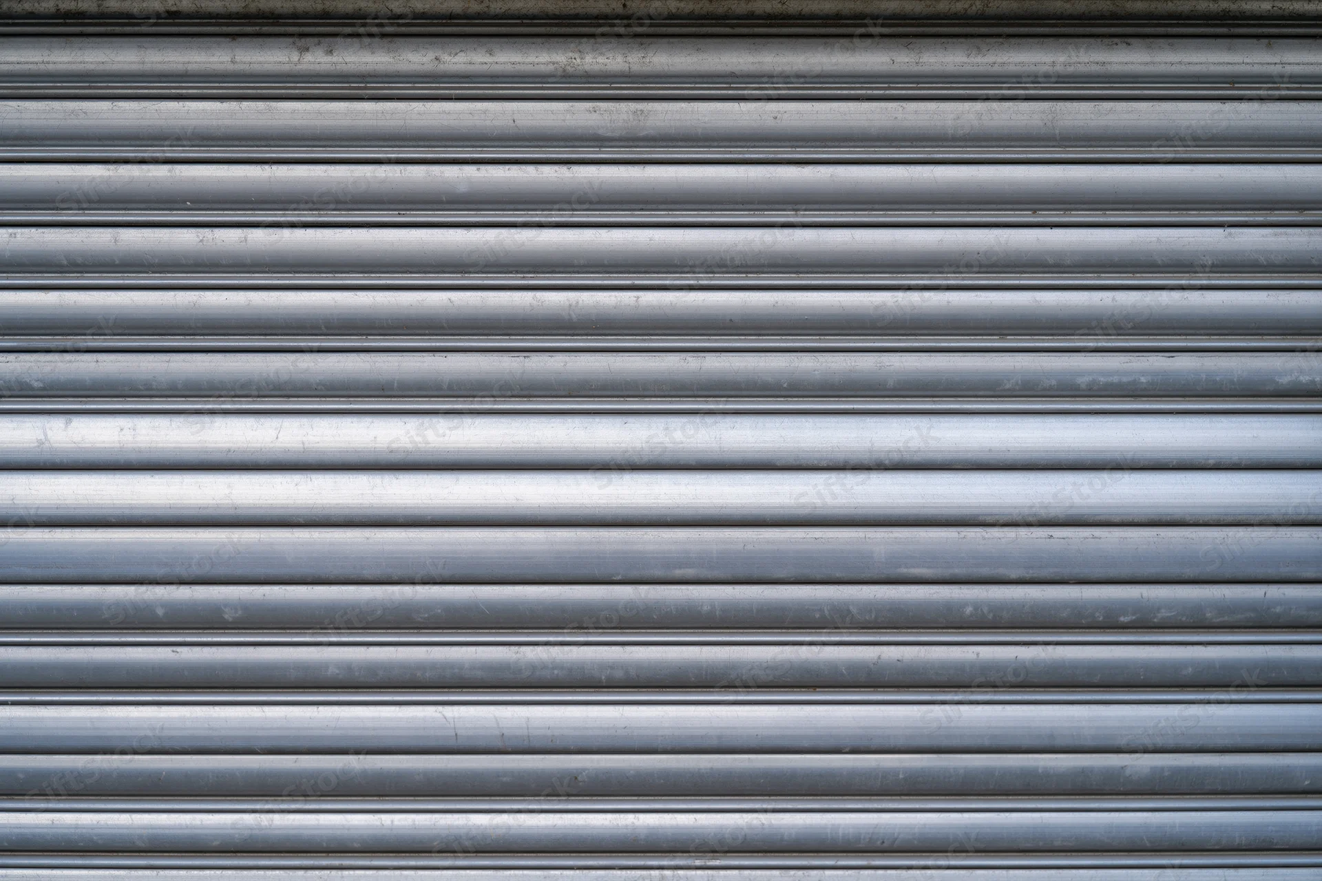 Close-up of a corrugated metal roller shutter door on a building exterior