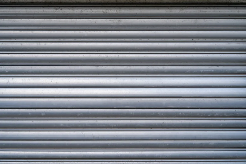 Close-up of a corrugated metal roller shutter door on a building exterior