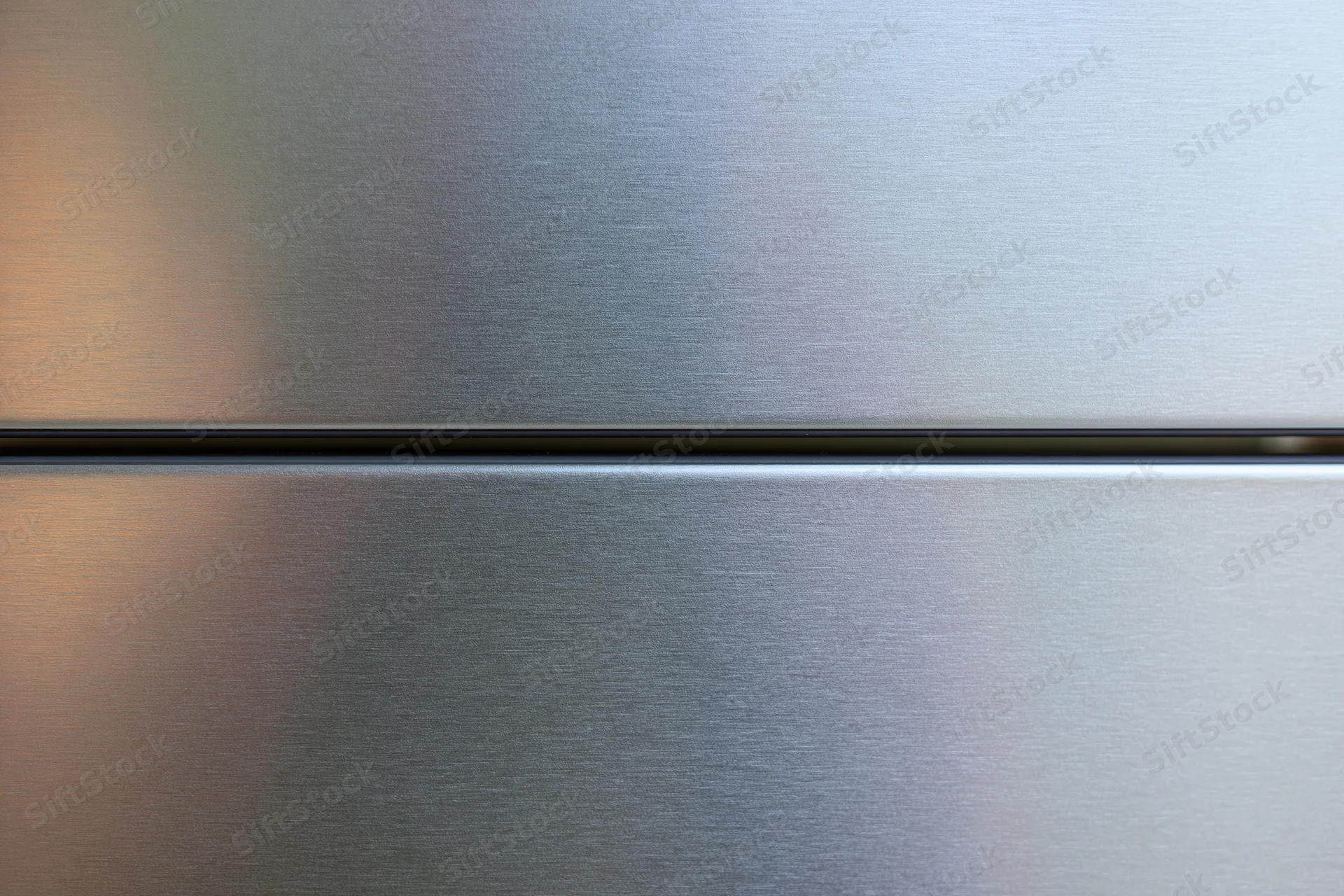Close-up of brushed stainless steel refrigerator door panels