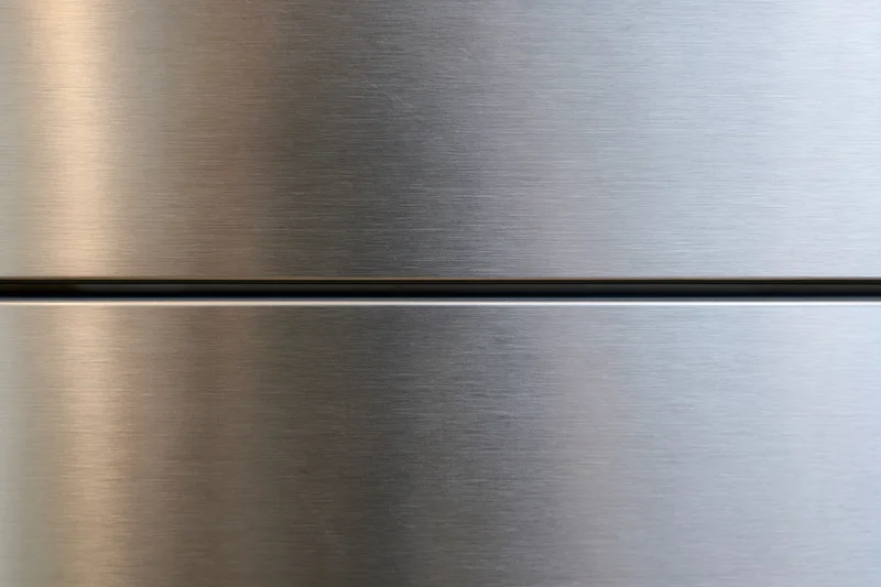 Close-up of brushed stainless steel refrigerator door panels