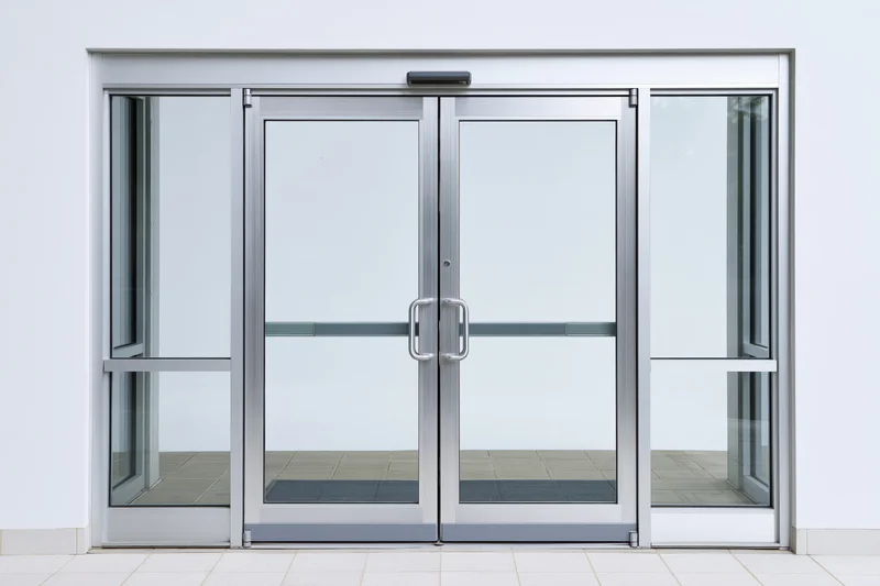 Double glass doors with aluminum frames centered in a building entrance