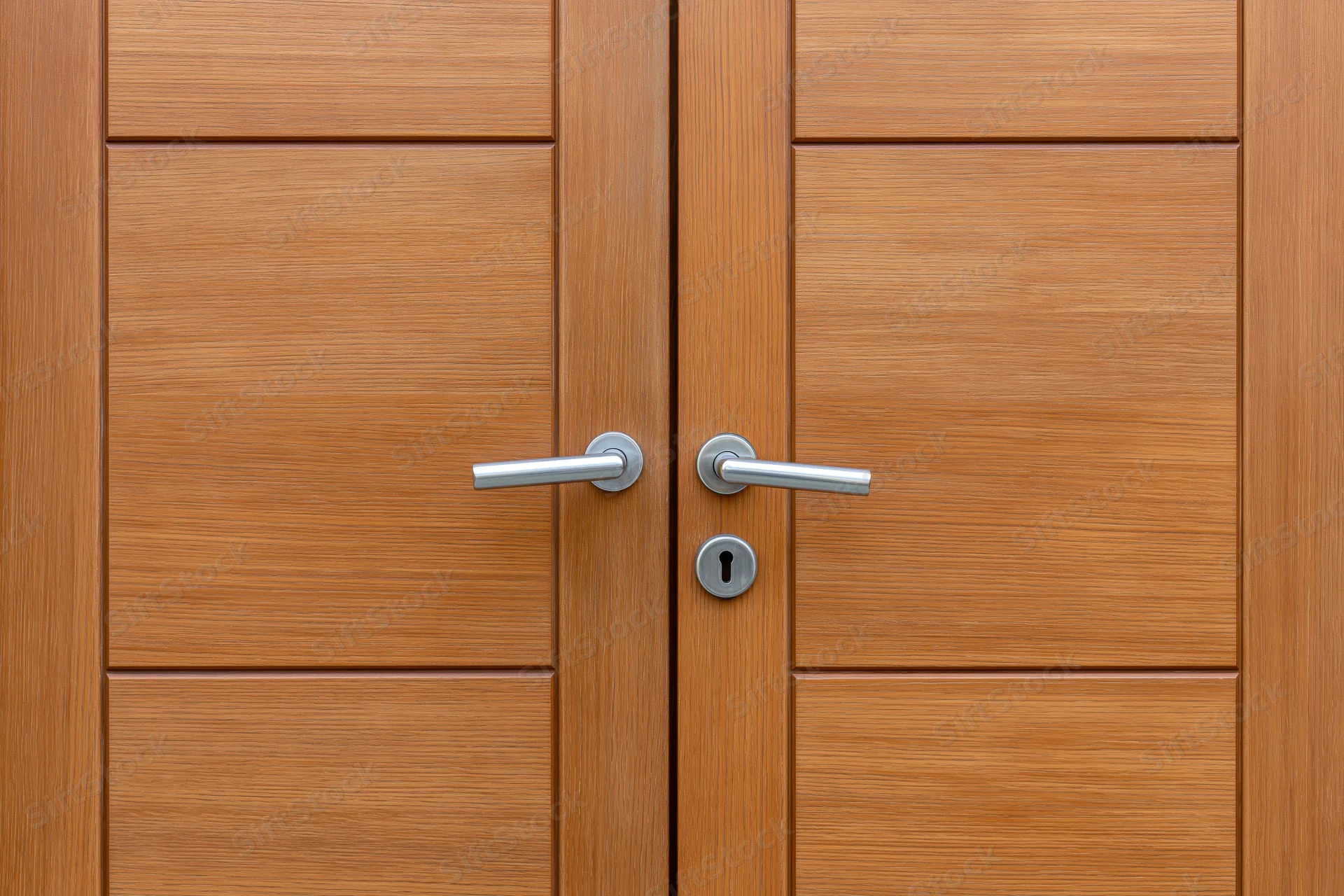 Double wooden door with brushed chrome lever handles and keyhole