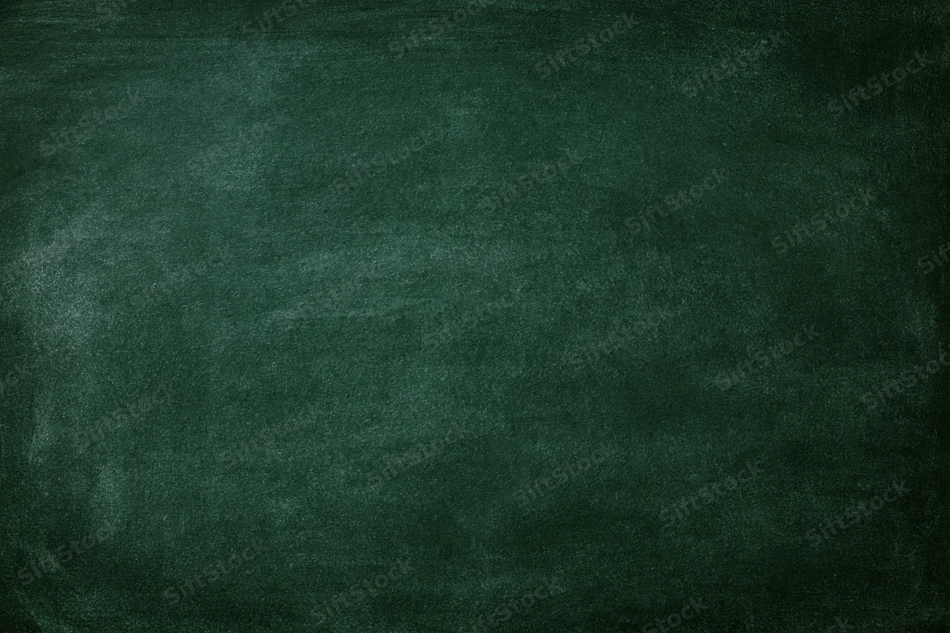 Dark green chalkboard surface filling the frame with faint smudges and texture