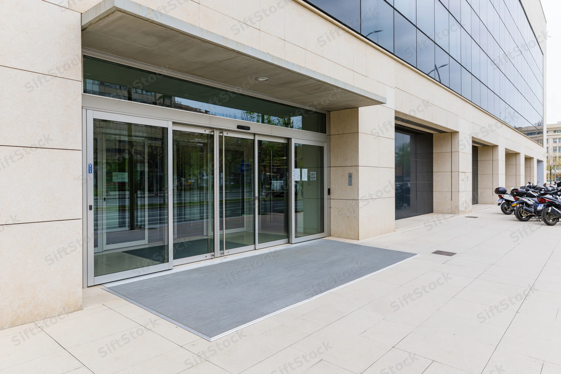 Automatic glass doors at the entrance of a modern corporate office building
